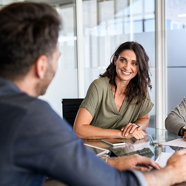 Smiling mature couple meeting with wholesale investments broker.